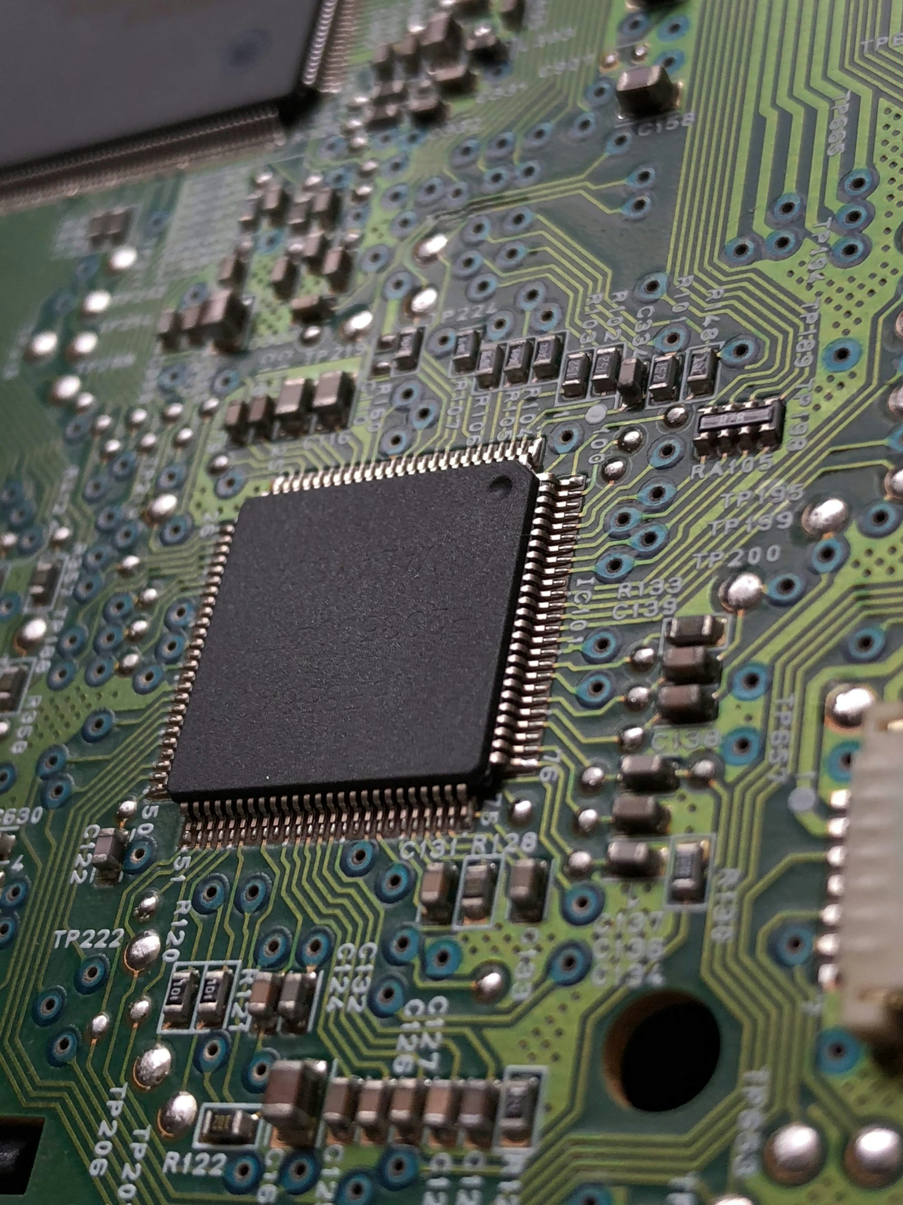 Macro photograph of an integrated circuit and surrounding board traces
